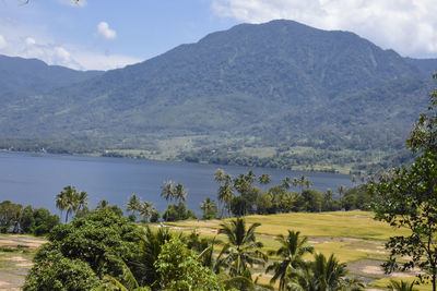 Scenic view of lake and mountains against sky