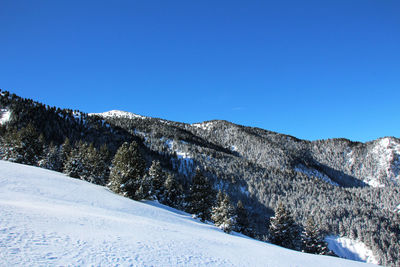 Scenic view of mountains against clear blue sky