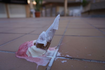 Close-up of ice cream on footpath