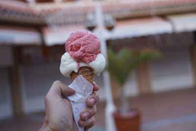 Hand holding ice cream cone