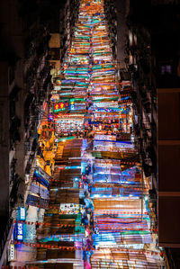 Low angle view of illuminated multi colored buildings in city at night