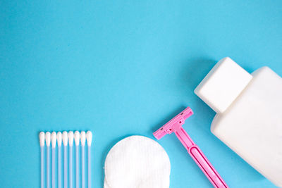 High angle view of cleaning equipment against blue background