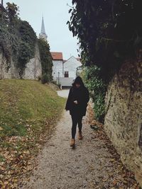 Full length rear view of man walking on street