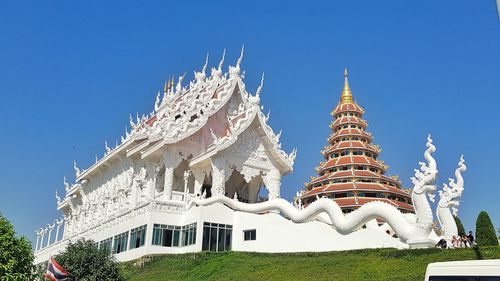 Low angle view of traditional building against blue sky