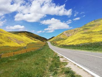 Empty road along countryside landscape