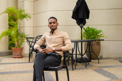 Young man sitting on table