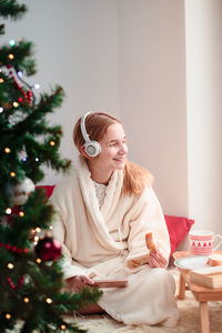 Woman with christmas tree at home