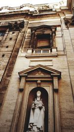 Low angle view of statue against building