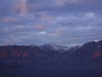 Scenic view of mountains against cloudy sky