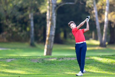 Teenage boy playing golf
