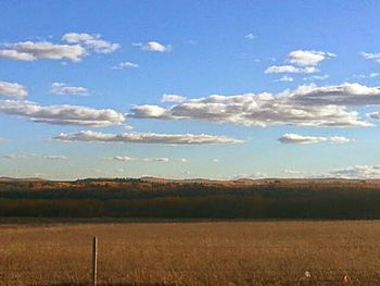 Scenic view of landscape against cloudy sky