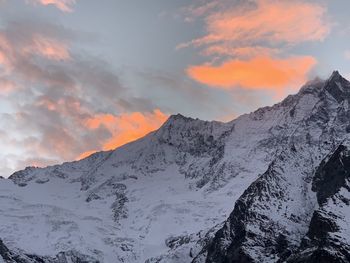 Scenic view of snowcapped mountains against sky during sunset