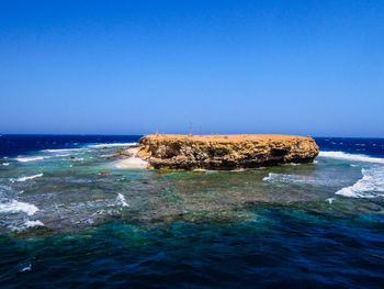 Scenic view of sea against clear blue sky