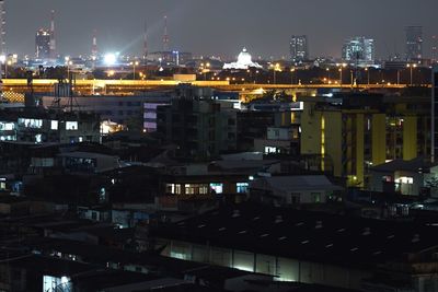 High angle view of illuminated buildings in city at night