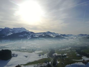 Scenic view of snowcapped mountains against sky during sunset