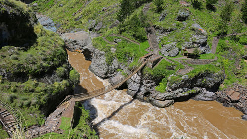 High angle view of stream amidst rocks
