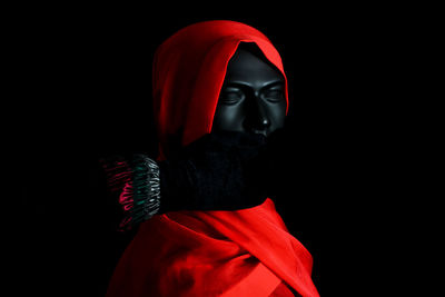 Portrait of person against black background