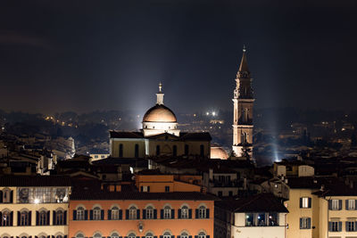 Illuminated cityscape against sky at night