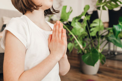 Close-up of the girl's hands folded for prayer. relaxation and yoga practice for kids