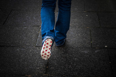 Low section of person standing on footpath