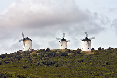 Traditional windmill on field against sky