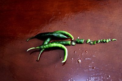 Close-up of green chili peppers on table