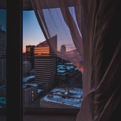 Man seen through glass window in city