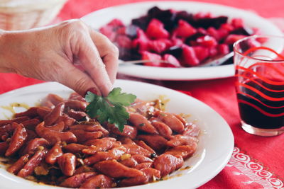 Close-up of hand holding food on table