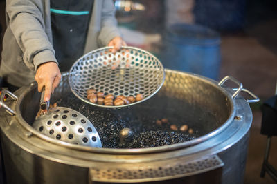 Midsection of person preparing food in kitchen