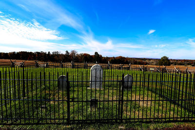 Fence on field against sky