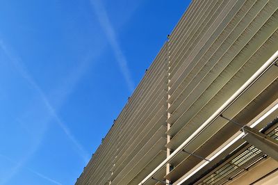 Low angle view of modern building against blue sky