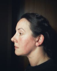 Close-up portrait of young woman looking away