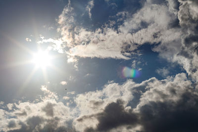 Low angle view of bright sun in sky