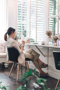 Woman sitting on chair at home