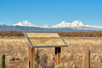 Scenic view of snowcapped mountains against clear blue sky