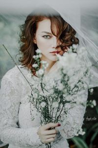 Portrait of young woman standing outdoors