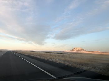 Road against sky seen from car windshield