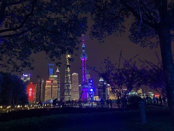 Low angle view of illuminated buildings against sky at night