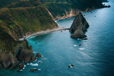 Overcast late-morning sky gives the coastal waters a darker hue of turquoise.