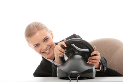 Portrait of a smiling young woman against white background