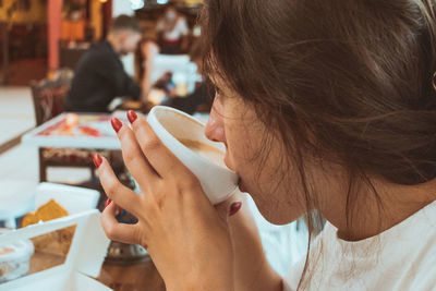 Close-up of woman holding coffee cup