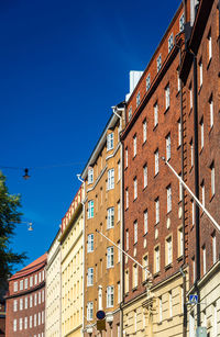 Low angle view of buildings against clear blue sky