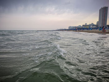 Scenic view of sea against sky in city