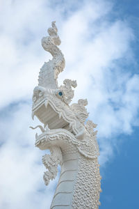 Low angle view of statue against cloudy sky