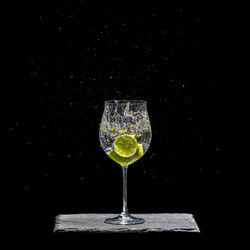 Glass of wine against black background