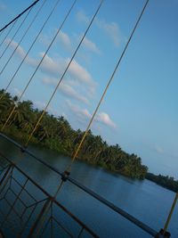 Power lines against cloudy sky