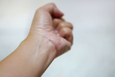 Close-up of woman hand on white background