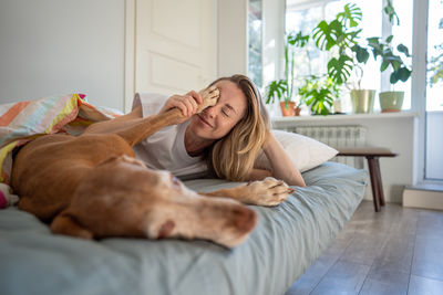 Young woman sleeping on bed at home