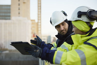 Two engineers working at construction site