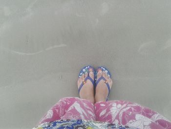 Low section of woman on sand